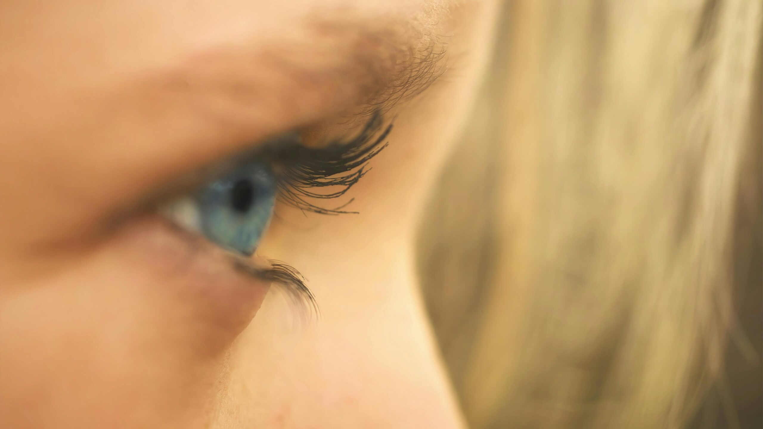 Detailed macro shot showcasing a blue eye and eyelashes, perfect for beauty and medical topics.